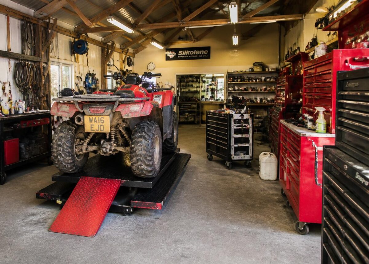 ATV workshop in the Cotswolds with a quad bike on the ramp and tool chests